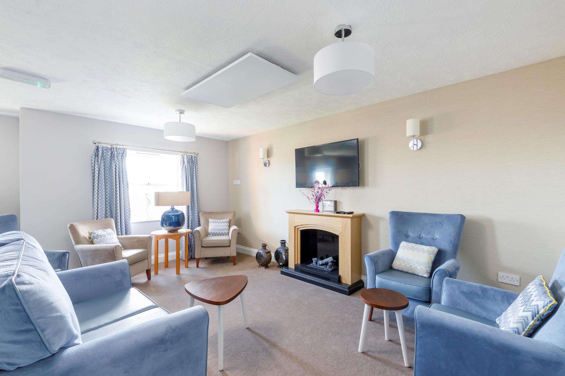 care home lounge with blue and beige armchairs